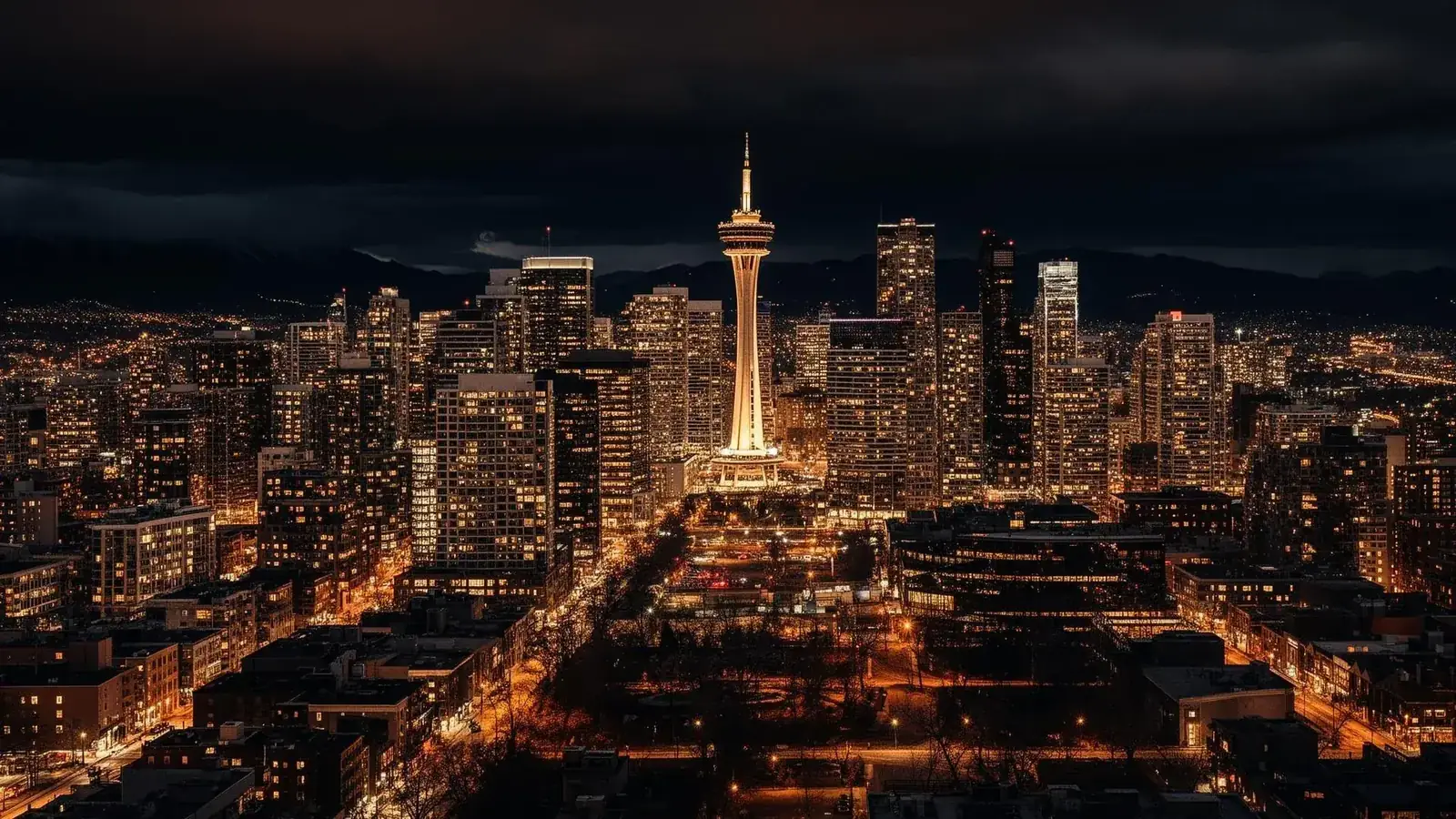 Black luxury limousine in front of the Calgary skyline at night